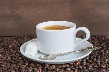 Cup of coffee on coffee beans 