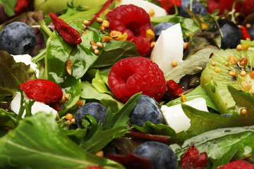 Green salad with arugula and berries, chia, goji