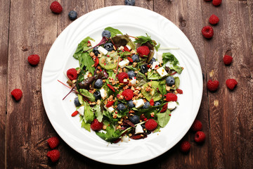 Green salad with arugula and berries, chia, goji