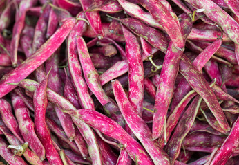 Pods of red beans on the counter farm market