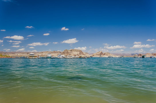 Sunny day at Lake Powell with boats and canyons in clear water - Powered by Adobe