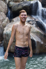 a man jumping off a cliff into the water