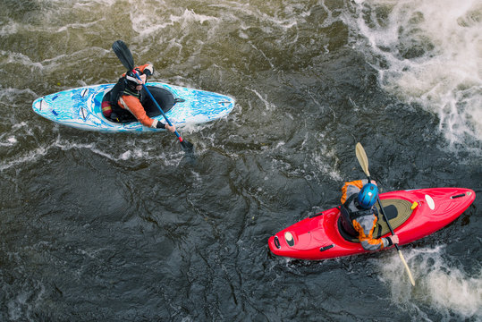 Overhead view of two kayakers paddling River Dee rapids