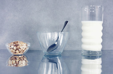 Oats cereals with milk on kitchen table, diet breakfast, healthy lifestyle
