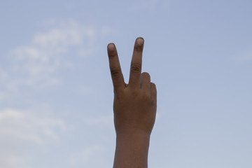 Hand with two fingers up in the peace or victory symbol