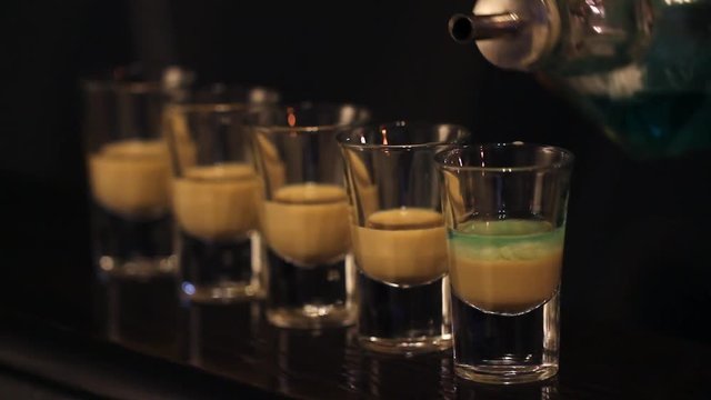Shots with whisky and liquor in cocktail bar