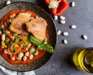 Fried chicken legs with white bean, vegetable and tomato sauce