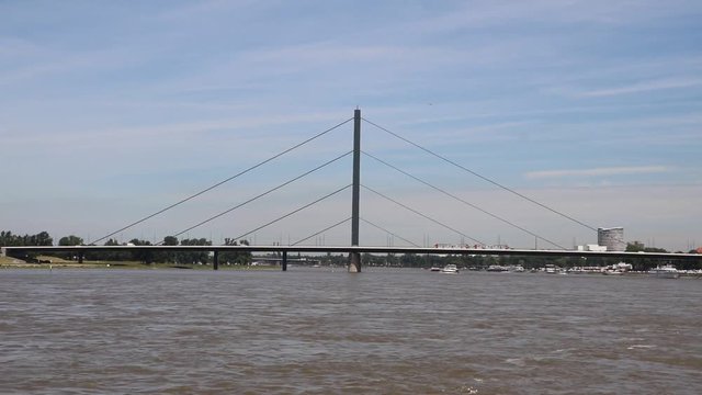 Traffic on and under the Oberkasseler bridge in Duesseldorf at river Rhine, Germany