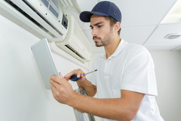 young contractor working carefully and seriously at clients office