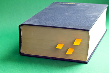 This is black book with yellow bookmarks. It is theme of reading.