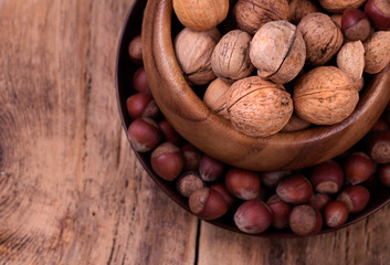 Walnuts and hazelnuts on rustic wooden background