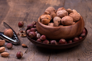 Walnuts and hazelnuts on rustic wooden background