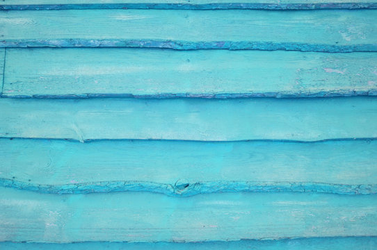 A cyan wooden wall background.    