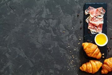 fresh croissants, bacon, tomatoes on a black background. top view. idea for breakfast - 127334049
