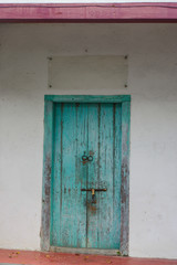 closed old blue wooden door. Mediterranean style exterior.