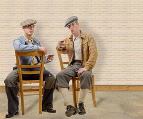 two young men with clothes and cap in 30s style.