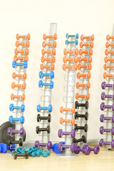 The image of dumbbells in a fitness hall