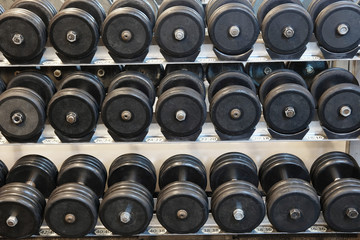 Fototapeta na wymiar The image of dumbbells in a fitness hall