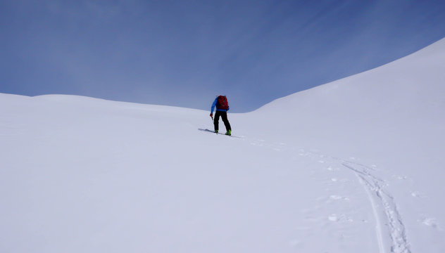 a backcountry skier climbing a mountain in the Swiss Alps near St. Moritz