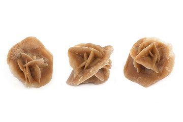 Desert rose isolated on white background. Crystal in three position.