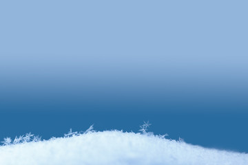 Blue winter background with snow and snowflakes