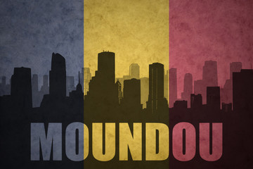 abstract silhouette of the city with text Moundou at the vintage chad flag