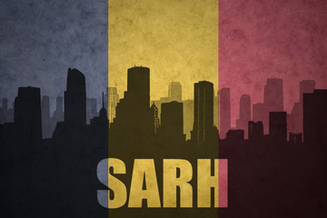 abstract silhouette of the city with text Sarh at the vintage chad flag