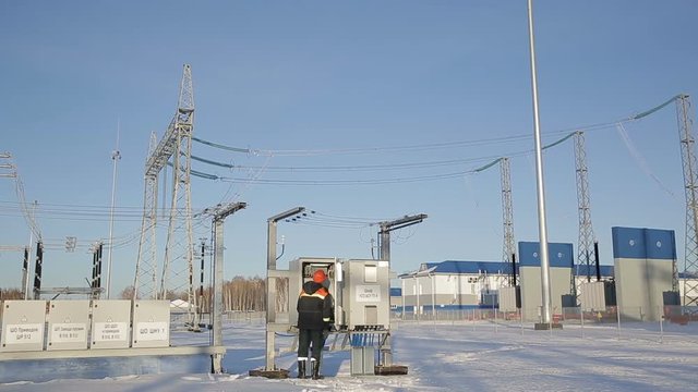 Electrician inspect equipment at the substation