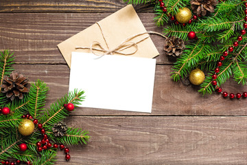Fototapeta na wymiar christmas greeting card with envelope on wooden background