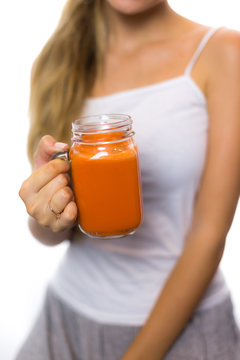 Woman holding a carrot juice diet is a healthy diet smiling helpful