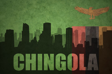 abstract silhouette of the city with text Chingola at the vintage zambian flag