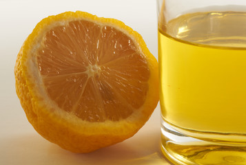 lemon and a glass of lemonade on a white background