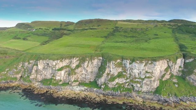 The big mainland in Carrick-a-Rede Rope Bridge in Ireland where tourists enoy the scenery of the ocean  in Ireland