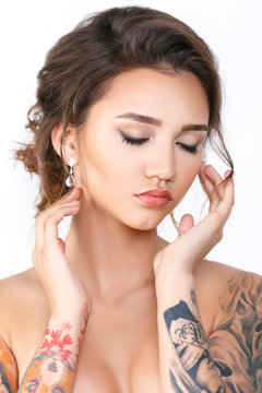 Beauty Fashion tattoo model with makeup and hair on a white background