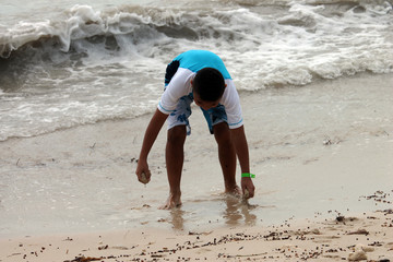 Fototapeta na wymiar Boy Playing in Sand