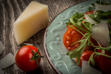 Salad with arugula cherry tomatoes parmesan and shallot