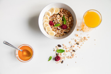 Breakfast with oatmeal and orange juice on white background