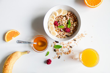 Breakfast with oatmeal and orange juice on white background