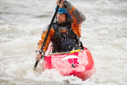 Male kayaker paddling River Dee rapids