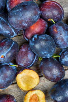 Fresh plums on a wooden table