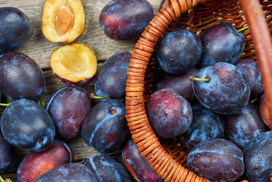 Pile of fresh plums in a wooden basket