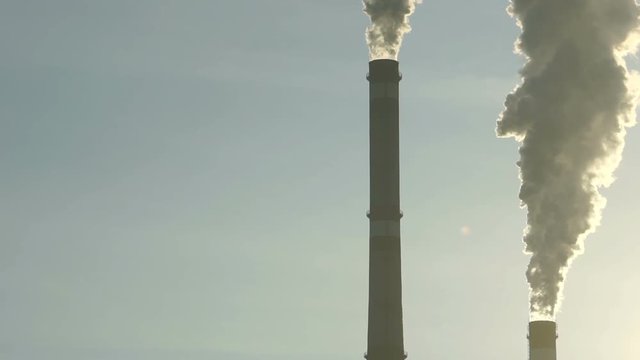 Footage industrial chimneys emits toxic pollutants into the sky polluting the environment