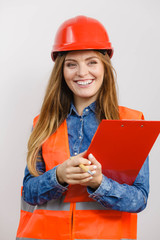 Woman engineer construction builder in helmet.