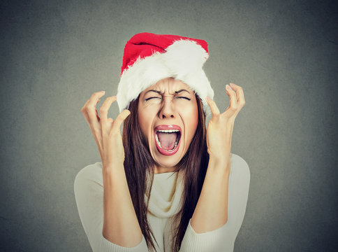 worried stressed overwhelmed woman wearing santa claus hat screaming