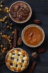 Top down view of 3 different pies - apple pie pumpkin pie and Pecan pie