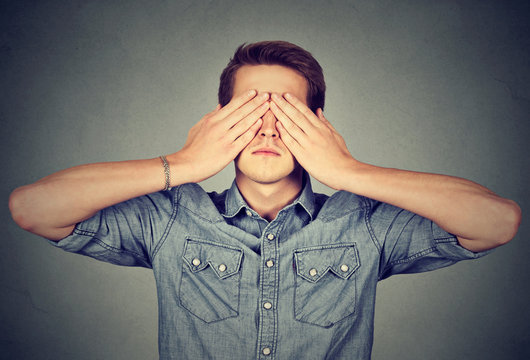 Man Covering Eyes With Two Hands