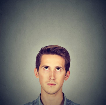 Man looking up gray background with copy space above head