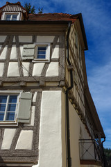 Fototapeta na wymiar Residential tudor style house with blue sky in background