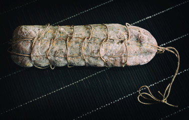 Italian salami seasoned black background