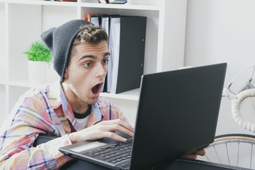 young man with the laptop at home